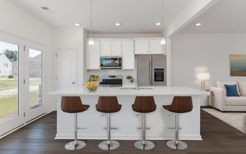 a kitchen with a bar stools